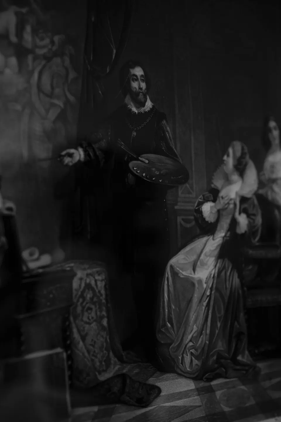 Black and white detail of an old painted portrait in a dim room