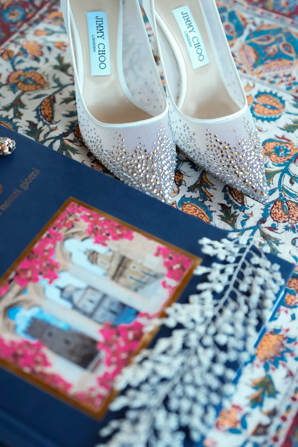 Wedding invitation and accessories laid out together, Sicily.